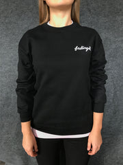 FEELINGS:  HAND on black fleece pullover